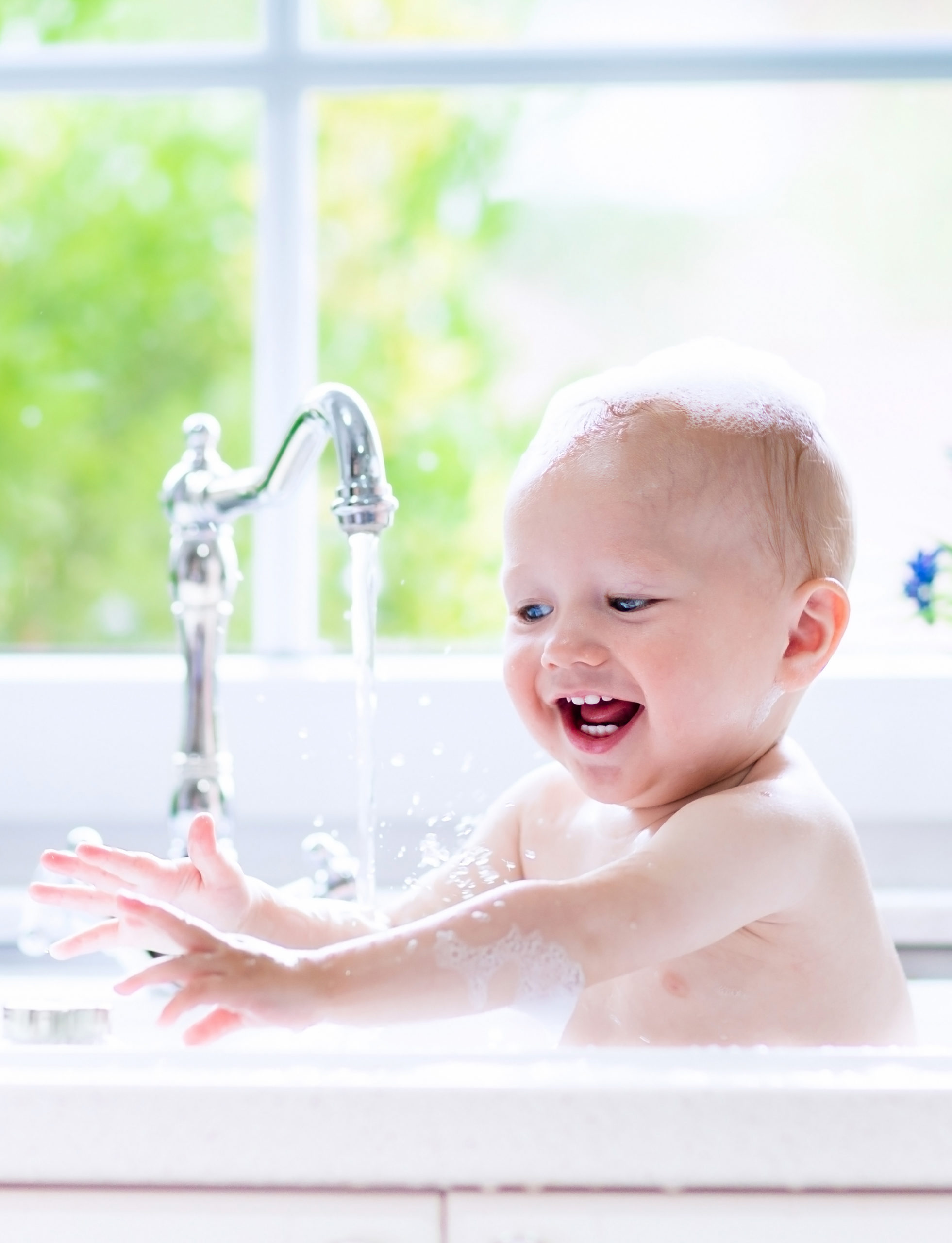 A baby enjoying hot water